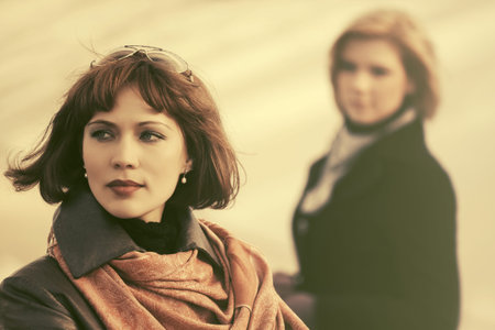 Two young fashion women in conflict in city street