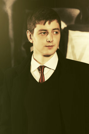 Young handsome business man walking in city street