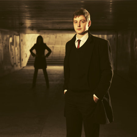Young handsome business man in underground tunnel