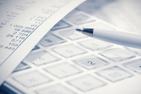 Financial accounting. Pen and calculator on business report
