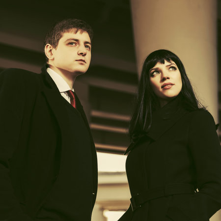 Young fashion business man and woman walking in city street
