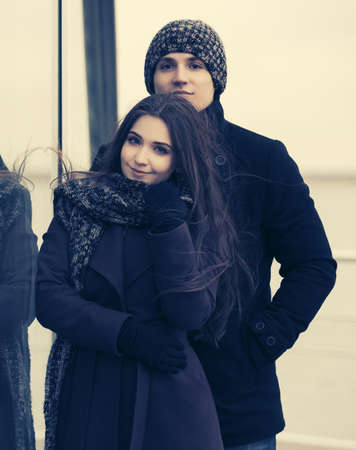 Happy young fashion couple in love Stylish man and woman wearing classic coats beanie and scarfの写真素材