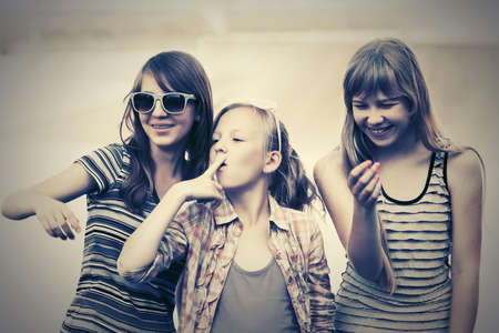 Group of happy teenage girls walking on city streetの写真素材