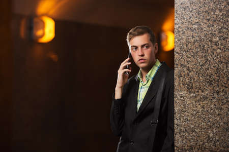 Young handsome business man calling on cell phone  Stylish fashion male model in black blazerの写真素材