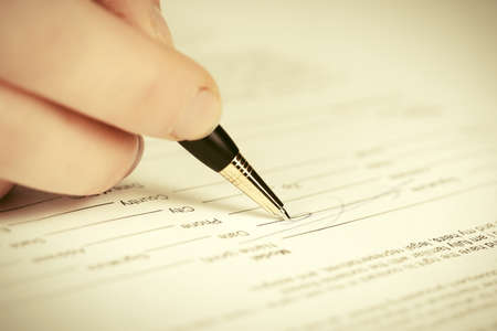 Close-up of business woman signing contractの写真素材