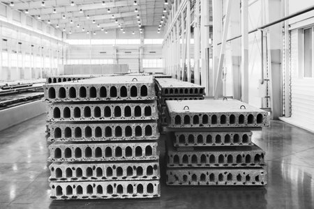 Stack of precast reinforced concrete slabs in a house-building factory workshop
