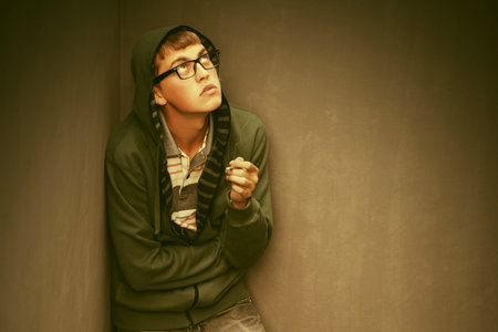 Sad young man in depression smoking cigarette  Stylish trendy male model in green hoodie