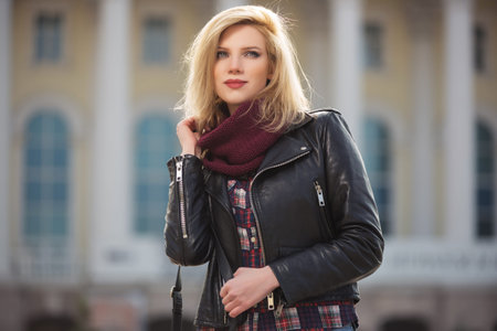 Young fashion blonde woman walking on city street  Stylish female model in black leather jacket and...