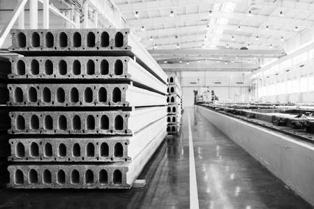 Stack of precast reinforced concrete slabs in a house-building factory workshopの写真素材
