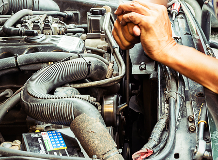 Hands of mechcanical  to engine repair in auto serviceのeditorial素材