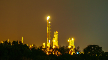Flames at the top of the fare stac and lighting in chemical industrail plant on night time.のeditorial素材