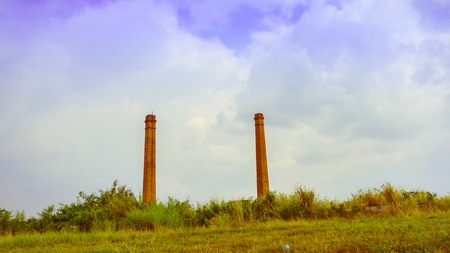 old chimney middle fiel with blue sky backgroundのeditorial素材