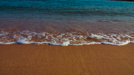 beautiful beach waves hit the beach for texture backgroundの写真素材