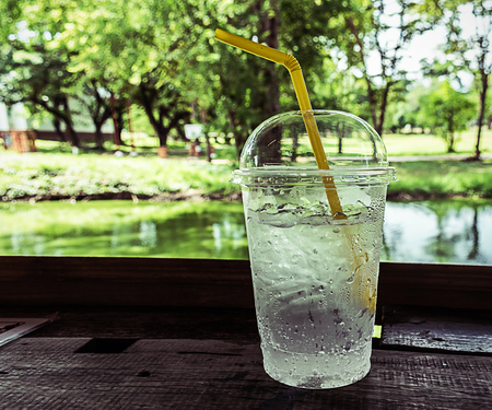 Ice water in plastic cup with yellow tubeの写真素材