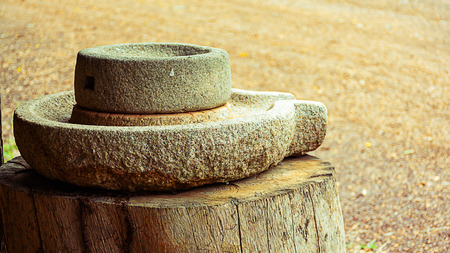 close up Ancient stone mill on tree woodの写真素材