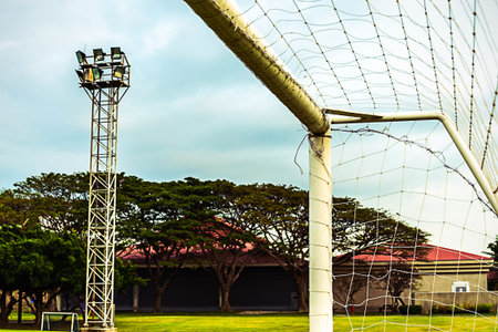 close up  football goal corner in field with trees and sky background