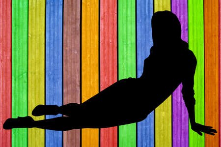 Woman s figure sitting on the ground on colourful backgroundの写真素材