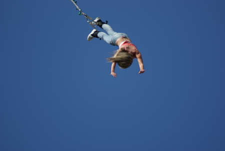 The Bungee, woman in time of jump, in air の写真素材