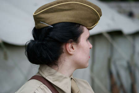 Woman soldier in cap, close relations のeditorial素材