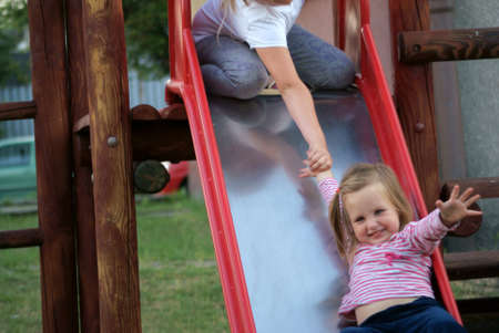 girl keep going down the slidesの写真素材