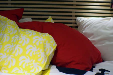Colorful pillows lying on the bed.の写真素材