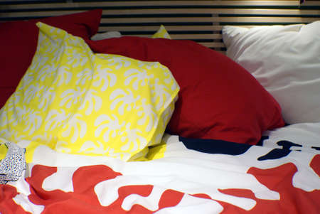 Colorful pillows lying on the bed.の写真素材
