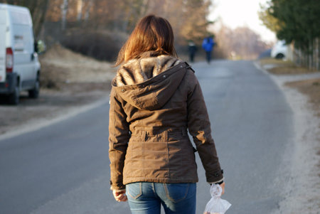 A woman going down the street.