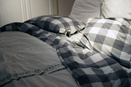Pillows and quilt lying on the bed.