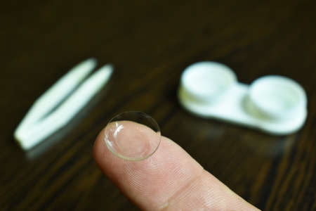 eye lens wear ,tweezers, storage container lenses on the tableの写真素材
