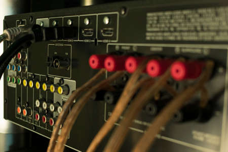 back of audio receiver video for home theater with inputs for connecting equipment and output to speakers with terminals and wiresの写真素材