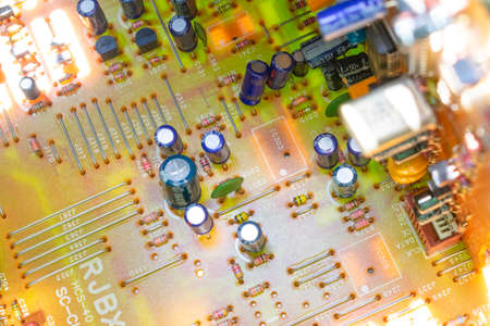 board with radio components - a transistor, a diode, a capacitor, a microchip, a transformer, a coil inside the amplifier of the sound of a radio-tape recorderの写真素材