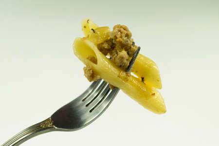 pasta with meat on fork close-up on empty backgroundの写真素材
