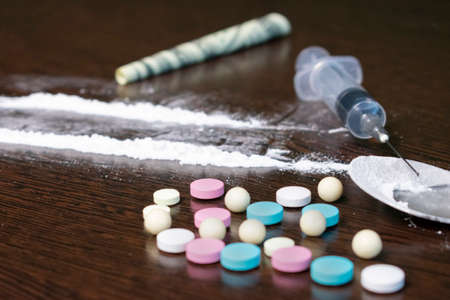 drugs in the form of powder, tablets and injections on the tableの写真素材