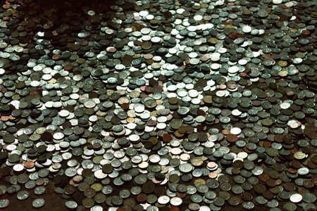 a lot of coins scattered on the groundの写真素材