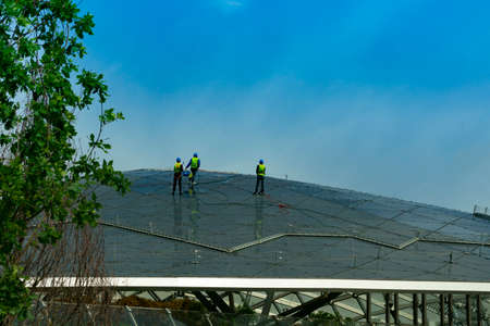 washing the glass roof of the building, roofing worksの写真素材