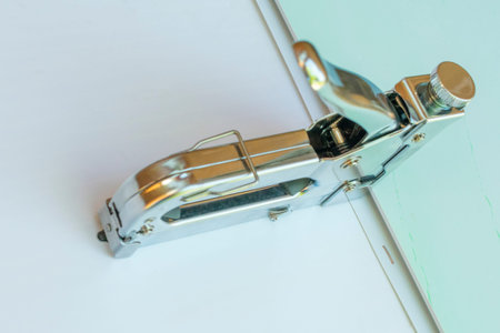 Stapler made of metal, for stapling panels in work.