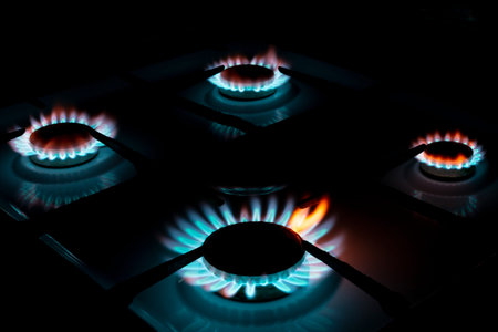 burning four gas cookers, in the dark, closeup