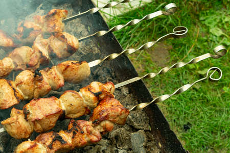 fried meat, shish kebabs, cooked on charcoal grill in the open airの写真素材