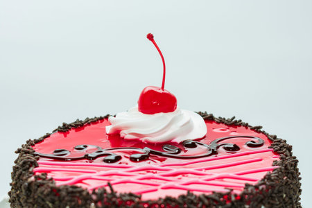 red cherry on a chocolate cake, on a white background.