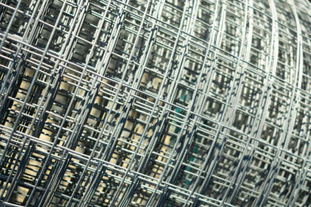 metal mesh twisted into a roll, close-up, as a background and abstractionの写真素材