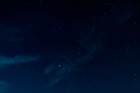 night starry sky with the constellation Cassiopeia, and a scattering of stars.の写真素材