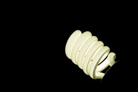 spiral fluorescent lamp isolated on black backgroundの写真素材