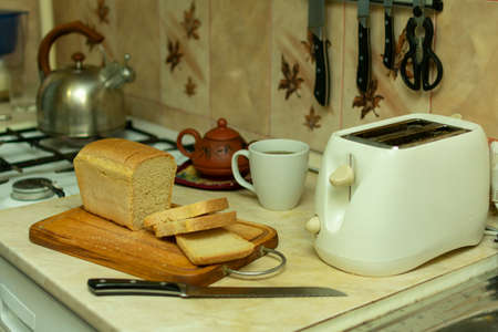 making breakfast toast bread with toaster at home kitchenの写真素材