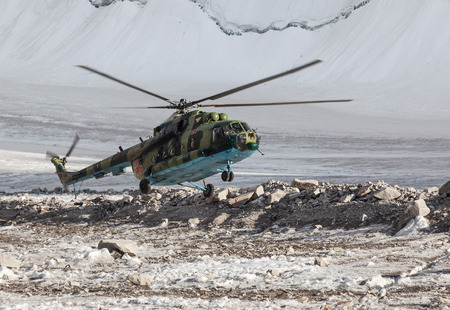 Military helicopter landing on ice of  mountain galcier in Ala Archa National Park (Kyrgyzstan)のeditorial素材
