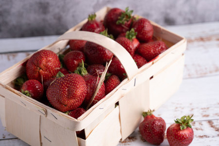 fresh strawberry in a small wooden basket. Photographed from aboveの写真素材