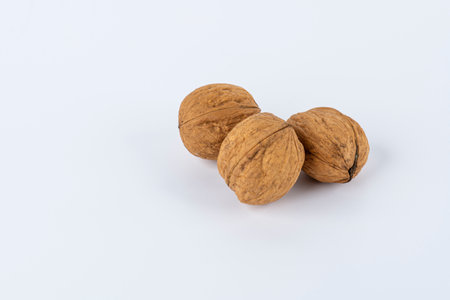Close up of three walnuts isolated against white backgroundの写真素材