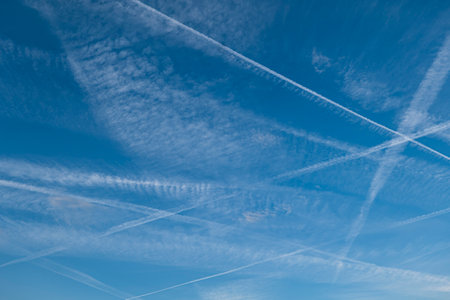 Pattern of several aircraft contrails in the blue skyの写真素材