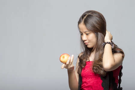 Asian teen holding an appleの写真素材