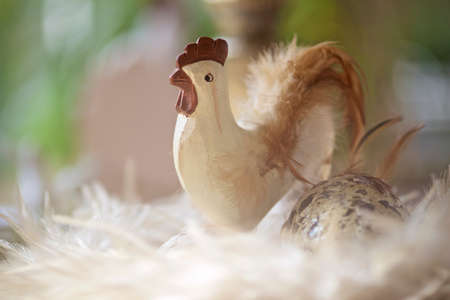 Easter decoration with rooster and feathersの写真素材