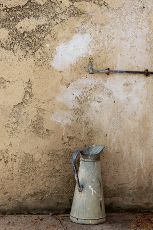 water pot in front of a stone wall